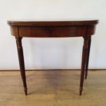 A 19th century mahogany demi lune card table, on turned reeded tapering legs, 92 cm wide Slight