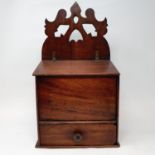 A 19th century mahogany candle box, with fret carved back and a hinged lid above a drawer, 41 cm