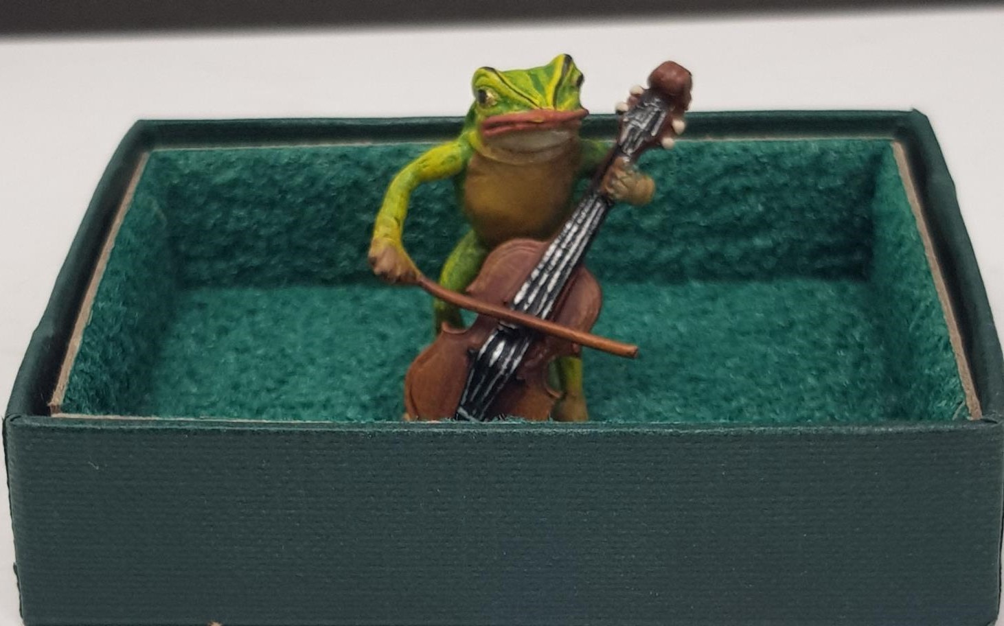A Petri Bronzen novelty cold painted bronze of a frog playing a cello, 3.5 cm high, and seven