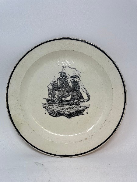 A 19th century creamware plate, bat-printed with a galleon, 25 cm diameter