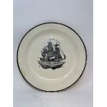 A 19th century creamware plate, bat-printed with a galleon, 25 cm diameter