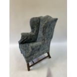 A 19th century style wing back armchair