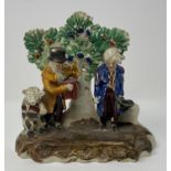An early 19th century Staffordshire group, of two men and a dancing bear, 16 cm high various losses