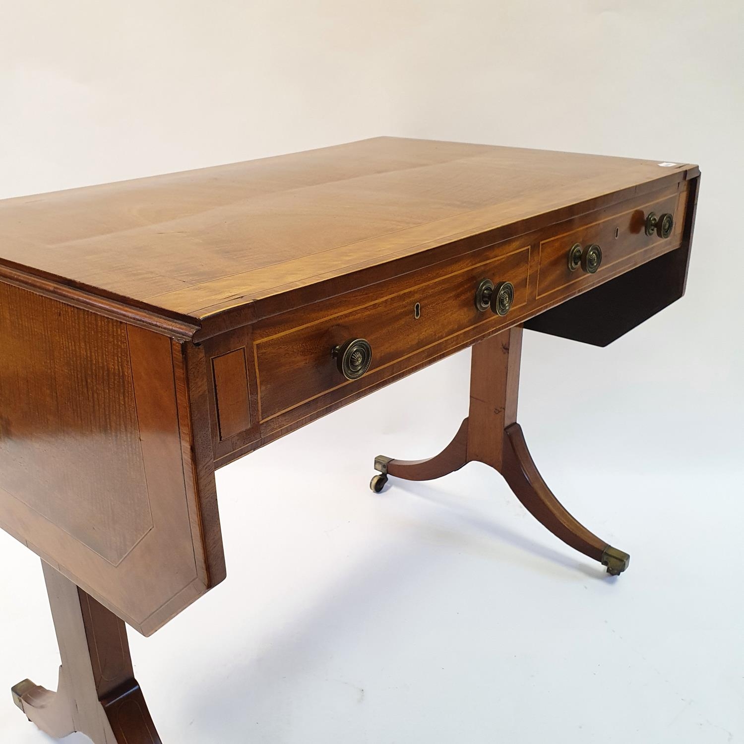 A 19th century mahogany sofa table, crossbanded in satinwood, with two frieze drawers, on end