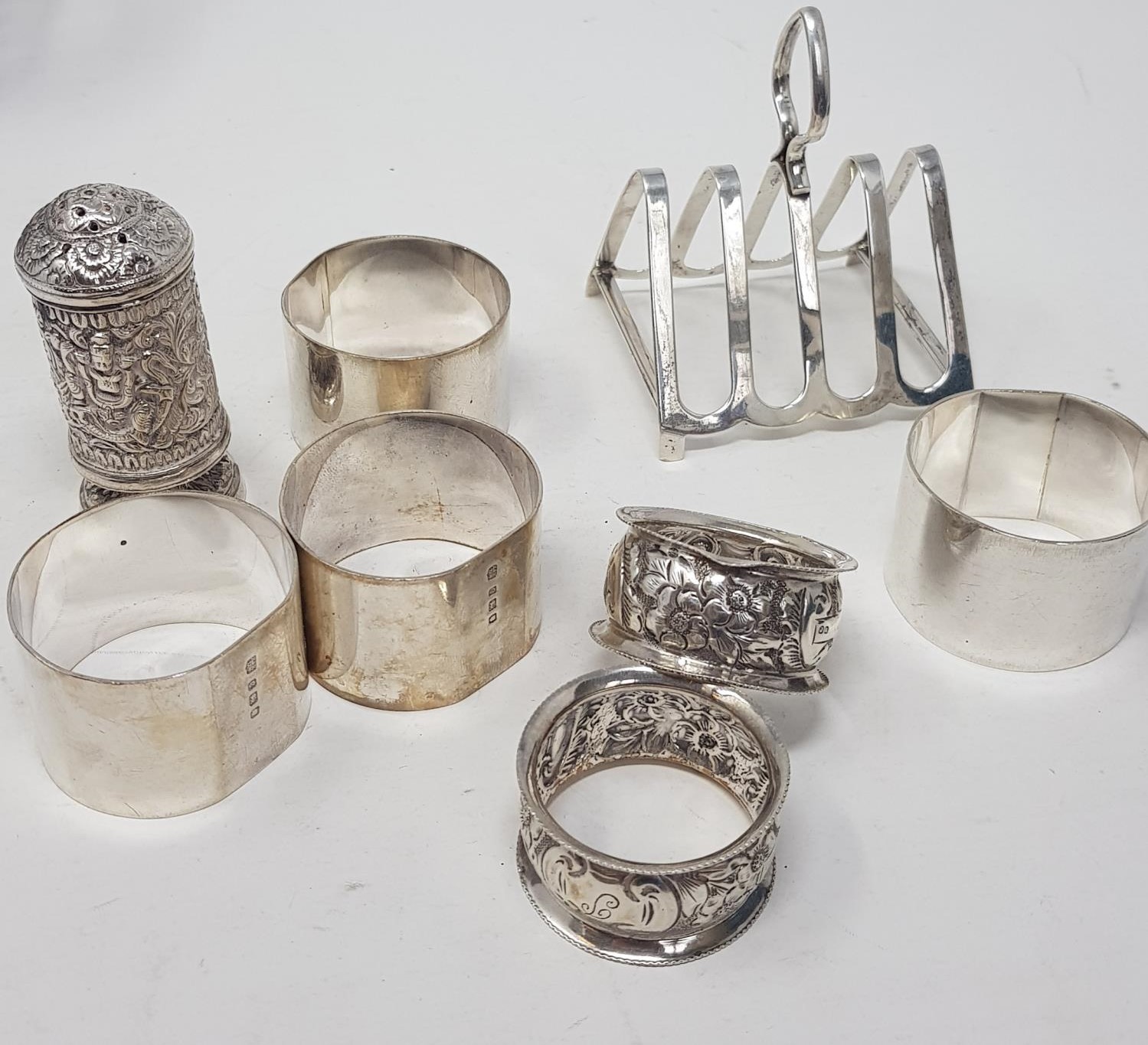 A silver toast rack, six silver napkin rings and an Indian silver coloured metal pepper pot, 9.5 ozt - Image 2 of 2