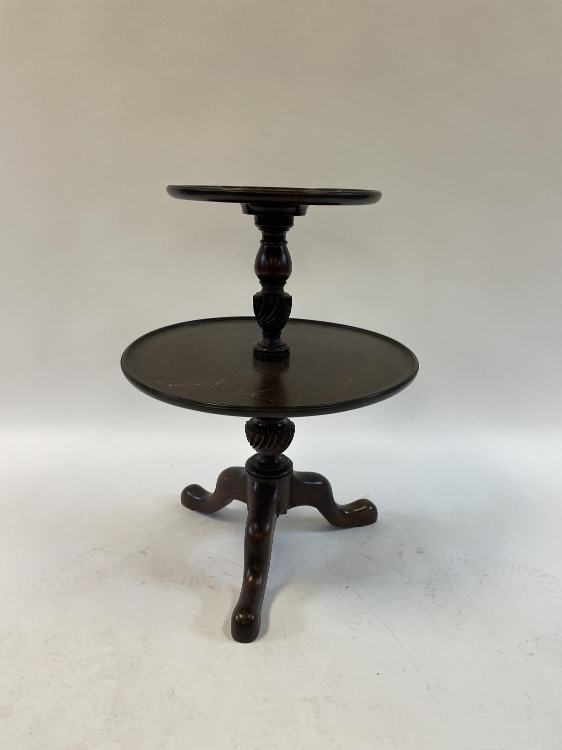 A mahogany two tier dumbwaiter, on a tripod base, top tier 36 cm diameter