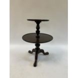 A mahogany two tier dumbwaiter, on a tripod base, top tier 36 cm diameter