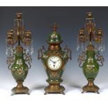 A clock garniture, the clock with an 8.5 cm diameter dial having Arabic numerals, in a pottery and