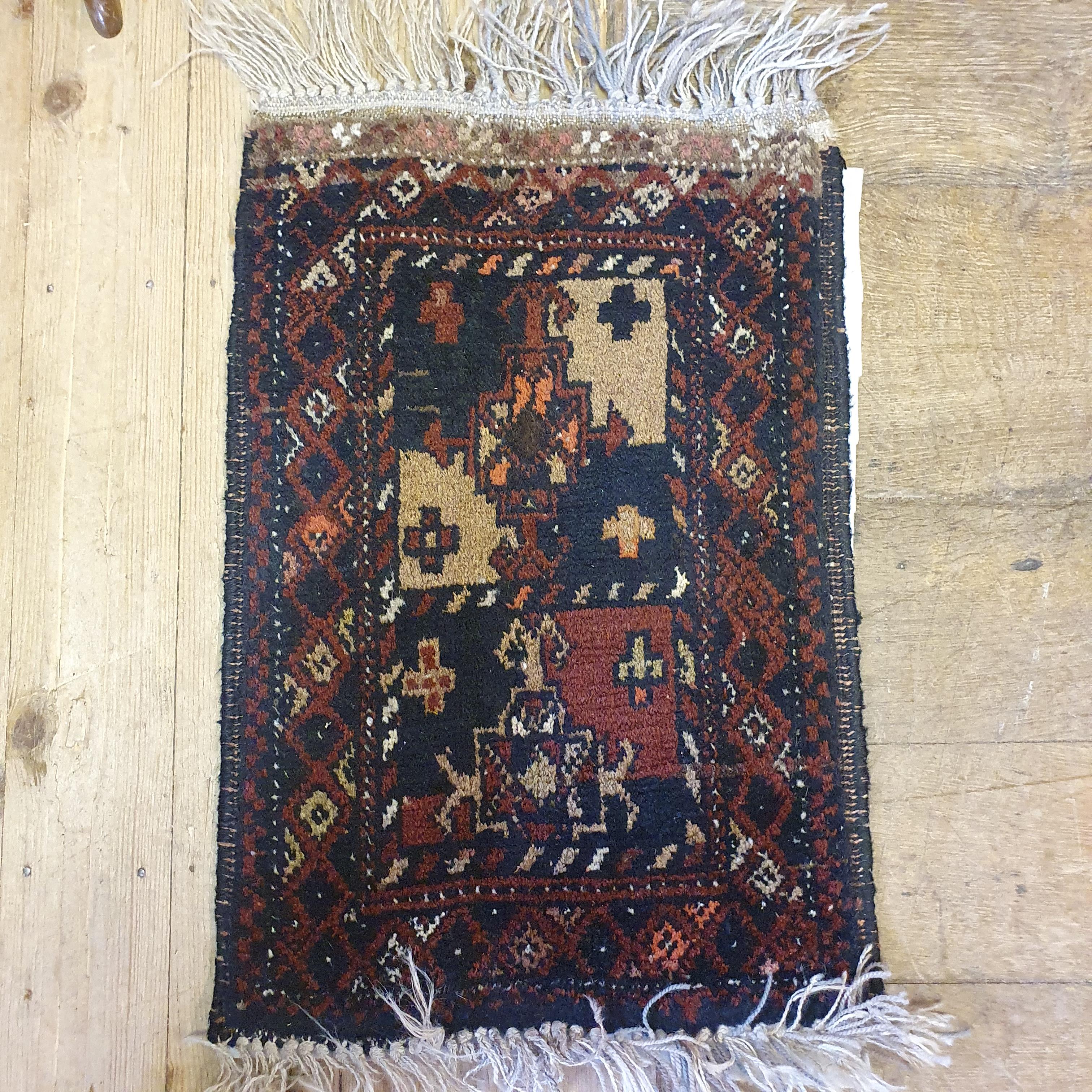 A Persian red ground rug, main blue boarder, the centre with three geometric medallions, 187 x 124 - Image 4 of 5