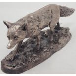 A silvered resin figure, of a fox, 13 cm wide