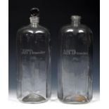 A pair of 18th century clear glass decanters and a stopper, probably Irish, engraved ABm