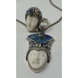 A silver and topaz carved face necklace, and a matching ring (2) This is a modern copy