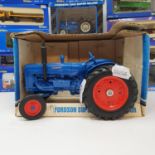 An Ertl Fordson Super Major Tractor, boxed and various other model trucks and tractors, all boxed (