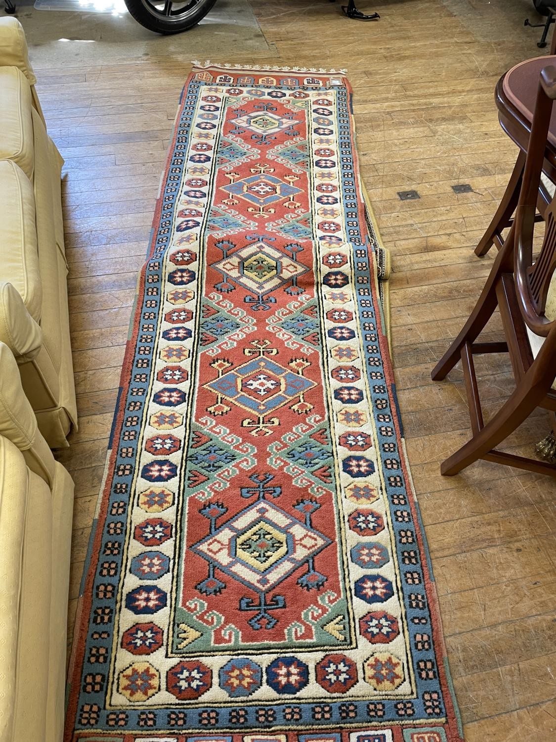 A Persian type red ground runner multiple borders centre with repeating lozenge shape medallions,