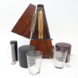 An early 20th century metronome, in a rosewood case, nine glass measures in leather cases and