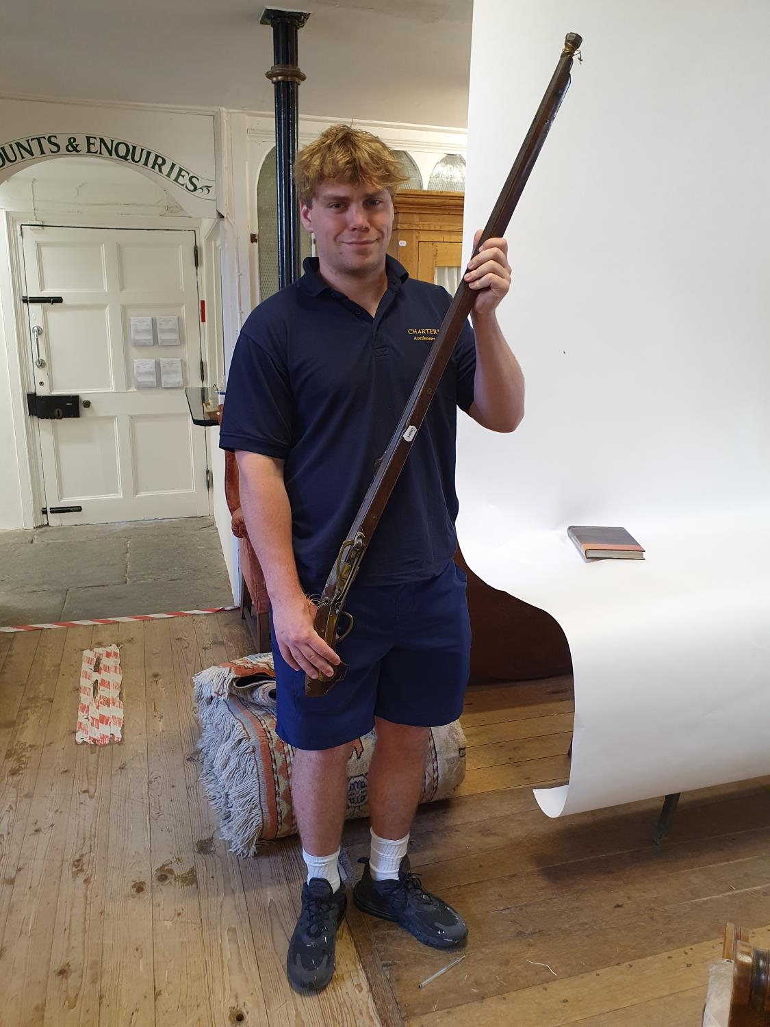 A Japanese matchlock long gun, the 106 cm sighted octagonal barrel on a wooden stock with brass