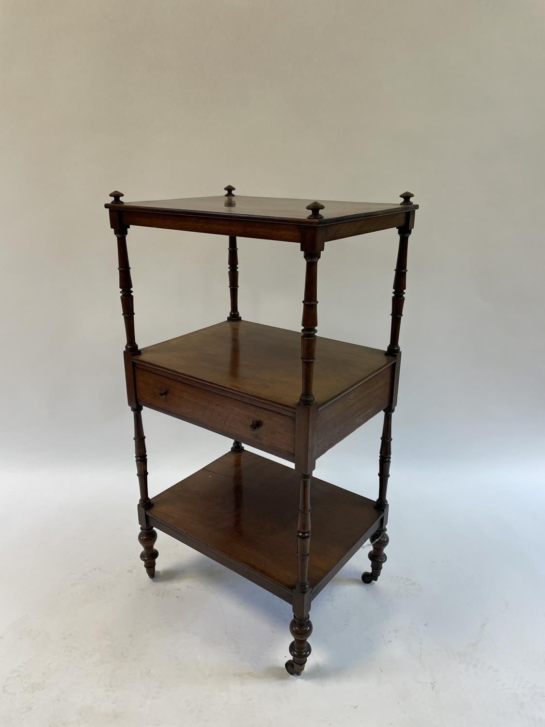 A 19th century mahogany whatnot, the central tier with a drawer, on turned legs, 55 cm wide