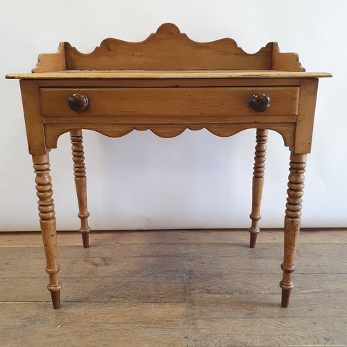 An early 20th century pine side table, with a single frieze drawer, on turned tapering legs, 83 cm