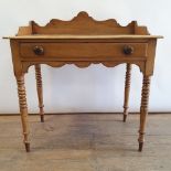 An early 20th century pine side table, with a single frieze drawer, on turned tapering legs, 83 cm