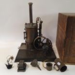 An early/mid 20th century vertical steam engine, on a plinth base, with attached pulleys, 50 cm