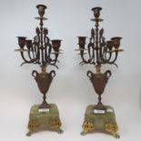 A pair of spelter and onyx five light candelabra, from a clock garniture, 46.5 cm high (2)