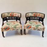 A pair of early 20th century ebonised tub chairs (2)
