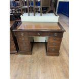 A mahogany pedestal desk, having nine drawers, 107 cm wide