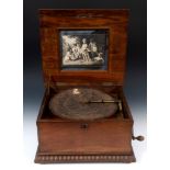 A late 19th century table top Symphonion, playing 33.5 cm diameter disc, in a walnut case, 45 cm