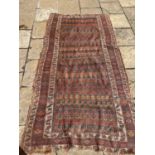 A Tribal rug, multiple borders, centre with repeating geometric forms, 240 x 119 cm