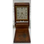 A Jaeger-Le Coultre travelling clock, with baton indices and Arabic numerals, in a leather case,