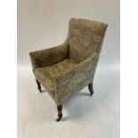 An early 19th century armchair, on turned tapering legs