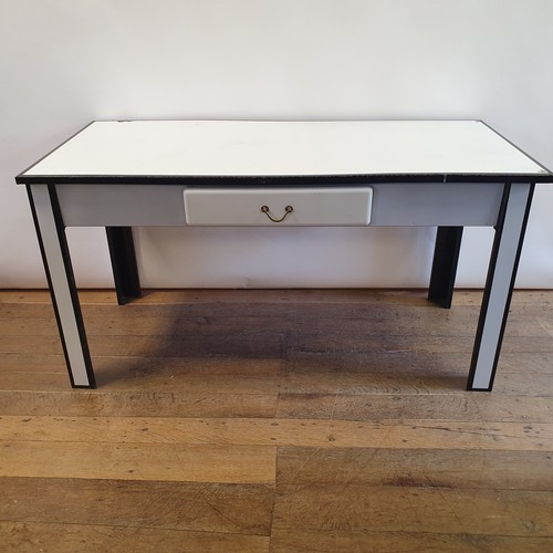 A white and black enamel table, with a single drawer, 145 cm wide