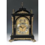 A late Victorian musical bracket clock, with repeat, the 18.5 cm arched square brass dial with a