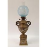 An oil lamp, with an acid etched shade, a clear glass well and a brass mounted marble base in the