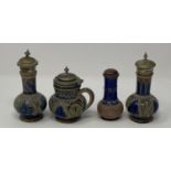 A Doulton Lambeth three piece cruet, and a pepper pot, 9 cm high (4)