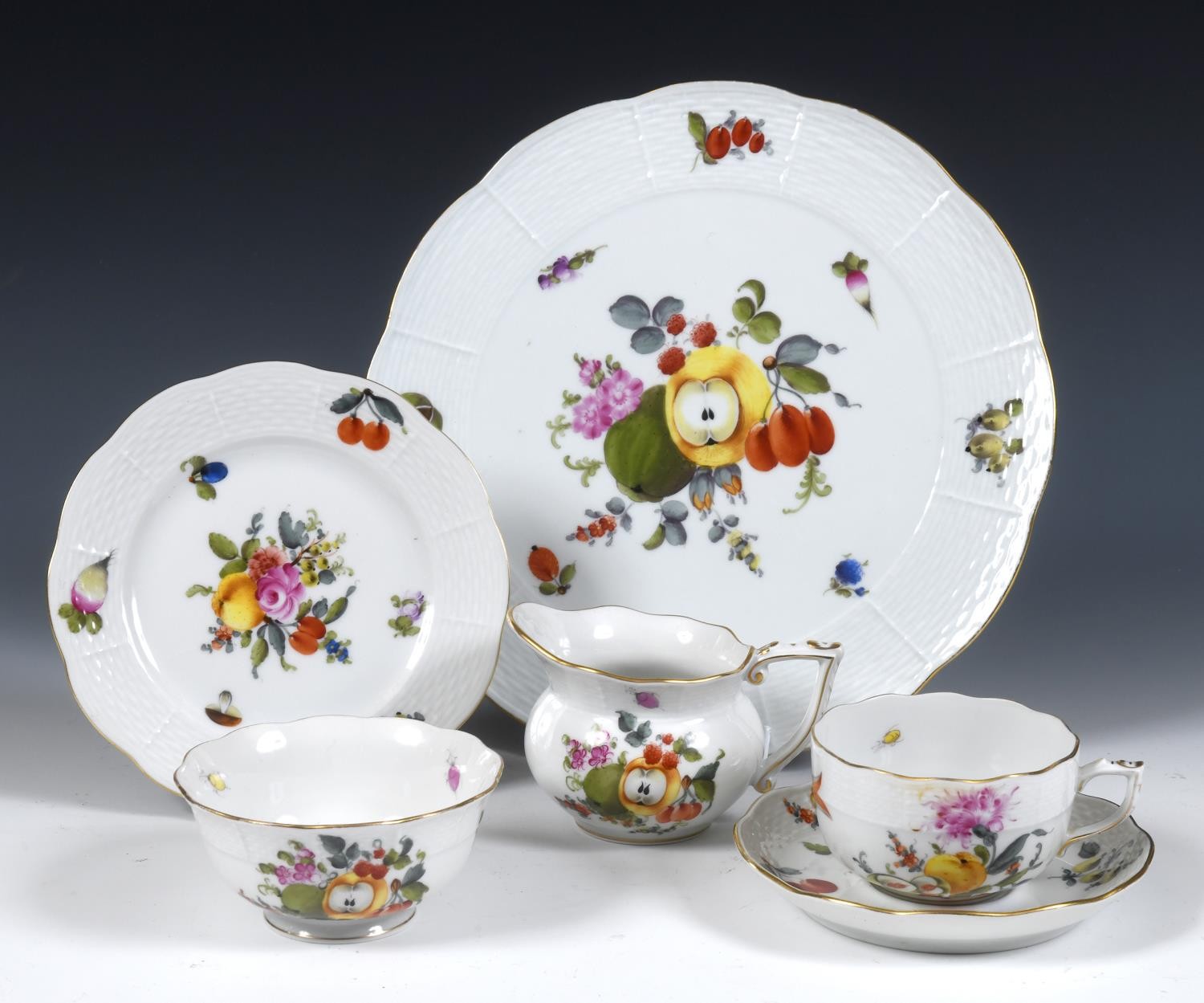 An Herend part tea service, comprising two plates, four side plates, seven cups and saucers, cream