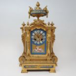 A late 19th century mantel clock, the 8.5 cm wide porcelain dial with Roman numerals and painted a
