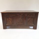 An 18th century oak coffer, with later carving, 90 cm wide