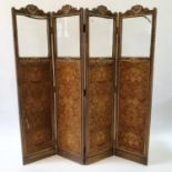 An early 20th century painted four panel screen, the top with glazed sections above silk panels