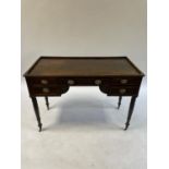 A 19th century mahogany kneehole desk, having five drawers, on turned tapering legs, 116 cm wide