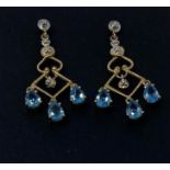 A pair of 9ct gold, diamond and blue topaz earrings