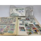 A large group of world stamps, and First Day Covers, loose and in albums (2 boxes)