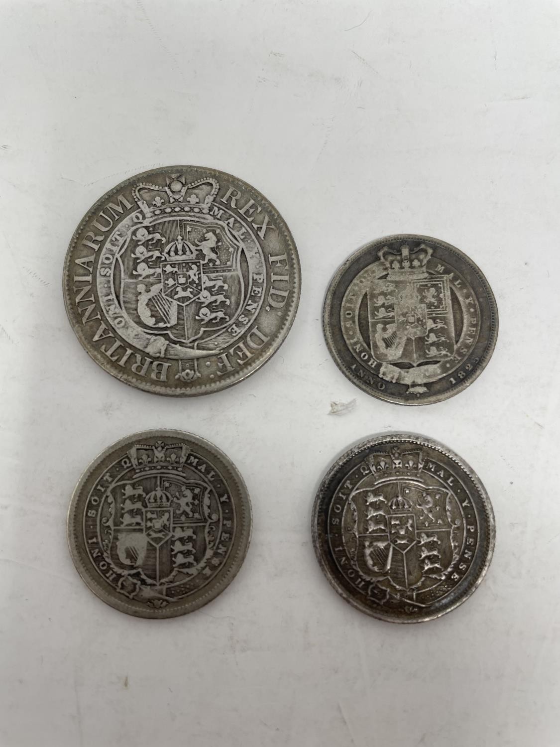 A George III half crown, 1819, and three George III shillings (4) - Image 2 of 2