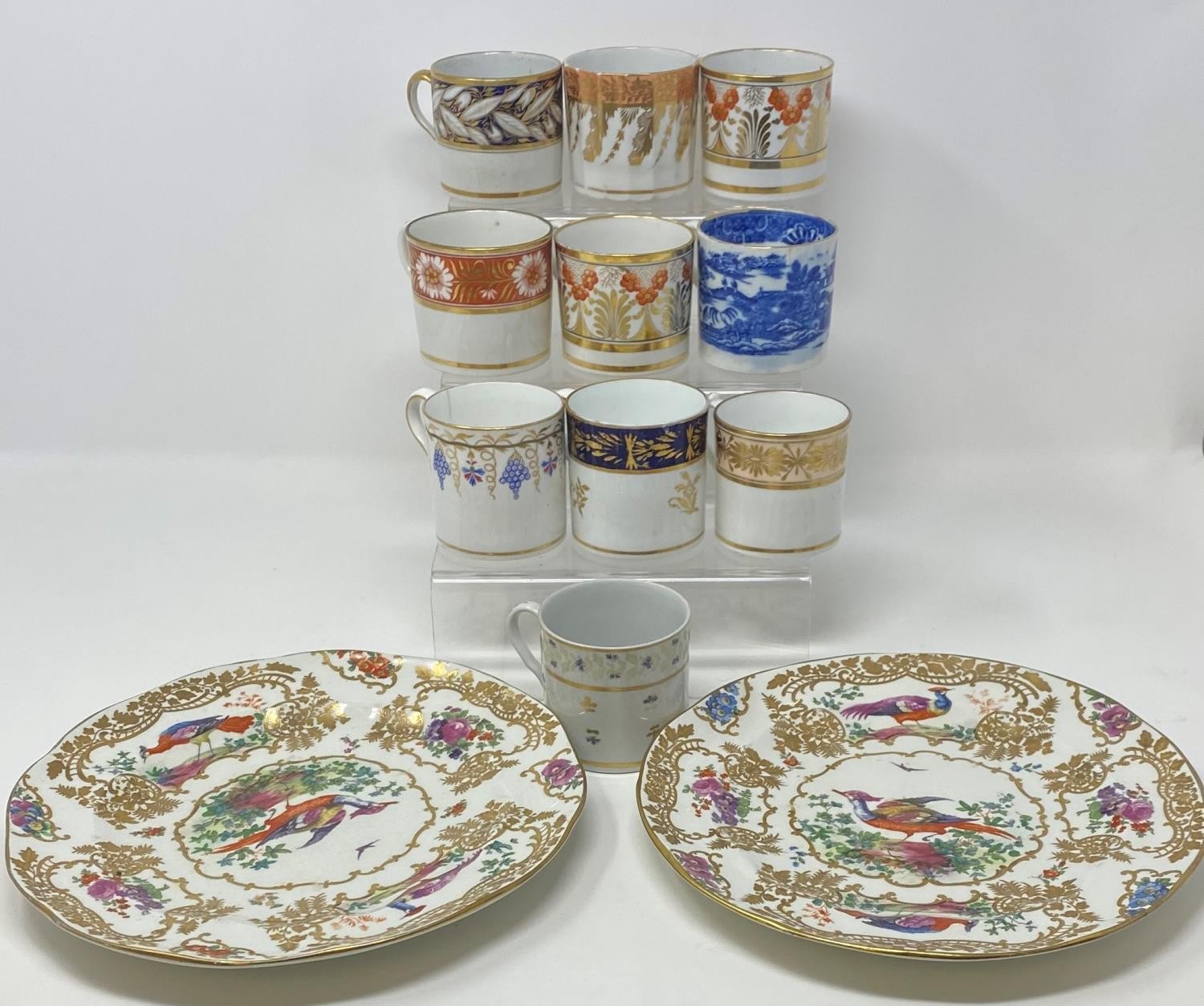 A 19th century porcelain coffee can, nine other coffee cans, and two plates (12)