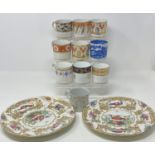 A 19th century porcelain coffee can, nine other coffee cans, and two plates (12)