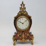 A Louis XVI style mantel clock, the 8.5 cm diameter dial with Arabic numerals, fitted an eight day