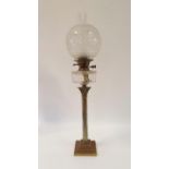 An oil lamp, with an acid etched glass shade and clear glass well on silver plated base in the