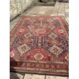 A Persian red ground carpet, multiple borders centre with repeating geometric medallions 356 x 256