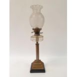 An oil lamp, with an acid etched glass shade, and a clear glass well on silver plated base in the
