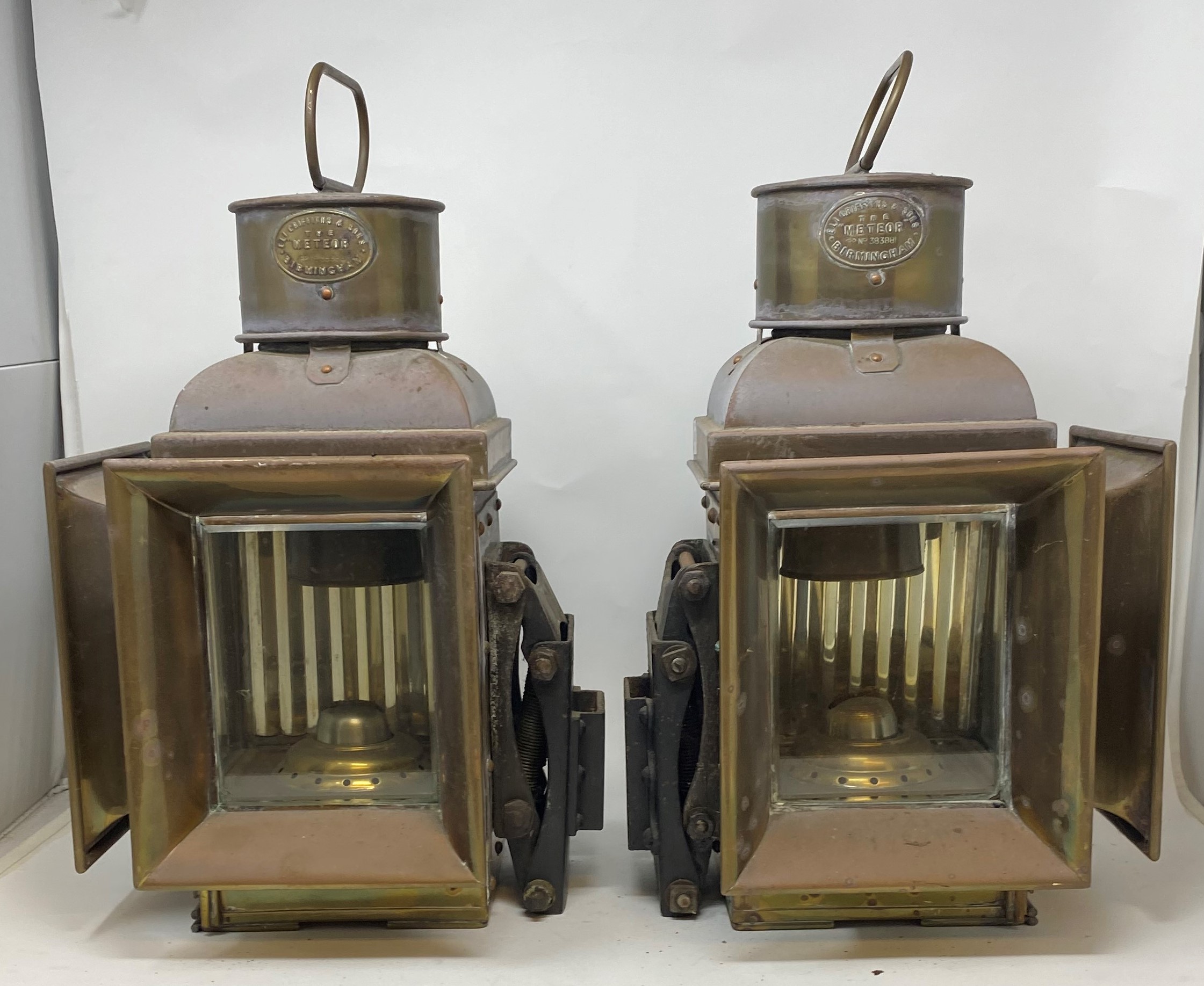 A pair of brass Eli Griffiths & Sons Meteor double sided lamps, 43 cm high